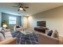 Cozy living room featuring stylish seating, a ceiling fan, and a large window at 2664 Chinaberry Hill St, Laughlin, NV 89029
