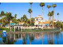 Resort-style community pool with palm trees and seating areas at 3125 N Buffalo Dr # 1089, Las Vegas, NV 89128