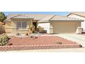 One-story house with desert landscaping and a two-car garage at 5025 Vista Loma Way, North Las Vegas, NV 89031