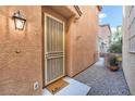 Front entrance with security door and welcoming mat at 3633 Water Song Dr, Las Vegas, NV 89147