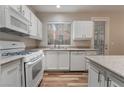 White kitchen with stainless steel appliances at 3633 Water Song Dr, Las Vegas, NV 89147