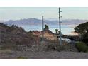 Scenic view of a home near the lake, with mountains visible in the background, under a clear sky at 868 Marina Dr, Boulder City, NV 89005