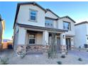 Two-story house with stone accents and a brown garage door at 9813 Belikove Manor Ave, Las Vegas, NV 89178