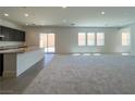 Bright open-concept living space with modern finishes and sliding doors to the backyard at 10208 Bismarck Palms Ave, Las Vegas, NV 89166