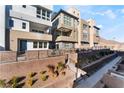 Modern townhome community with landscaped grounds and walkway at 655 Spotted Falcon St, Las Vegas, NV 89138