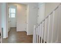 Bright hallway with tile flooring, leading to stairs and other rooms at 1029 Ferodale Ave, North Las Vegas, NV 89084