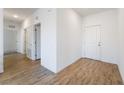 Clean and simple hallway with light walls and wood-look tile floors at 2555 Hampton Rd # 4308, Henderson, NV 89052