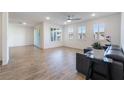 Open living room featuring wood-look floors and large windows at 2555 Hampton Rd # 4308, Henderson, NV 89052