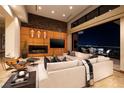 Open-concept living room with fireplace and city views through sliding glass doors at 1492 Macdonald Ranch Dr, Henderson, NV 89012