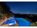 Resort-style pool and spa with city views under a starry night sky at 1492 Macdonald Ranch Dr, Henderson, NV 89012