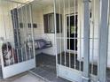 Inviting front porch with security gate featuring a cozy swing for relaxing outdoors at 3909 Woodhill Ave, Las Vegas, NV 89121