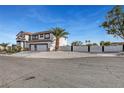 Two-story stucco home with a two car garage and desert landscaping at 6315 N El Capitan Way, Las Vegas, NV 89149