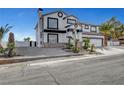 A two-story stucco home with palm trees and desert landscaping at 6315 N El Capitan Way, Las Vegas, NV 89149