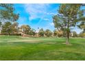 Scenic view of the golf course, lush green lawns, trees, and the Stratosphere in the background at 3125 Pinehurst Dr # A, Las Vegas, NV 89109