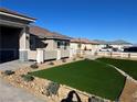 Landscaped front yard with artificial turf and drought-tolerant landscaping at 3060 Spy Glass Ave, Pahrump, NV 89048