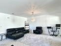 Spacious living area with plush seating, a chandelier, and large windows at 4428 W Lake Mead Blvd # 201, Las Vegas, NV 89108