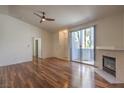 Spacious living room boasts hardwood floors, patio access, and a cozy fireplace at 4960 Harrison Dr # 214, Las Vegas, NV 89120