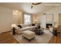 Inviting living room featuring a fireplace, plush sofa with an ottoman, and a neutral color palette at 4960 Harrison Dr # 214, Las Vegas, NV 89120