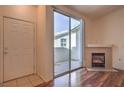 Living area features a fireplace, access to the patio, and tile and wood floors at 4960 Harrison Dr # 214, Las Vegas, NV 89120