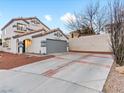 Front view of two-story house with driveway and landscaping at 2801 Willow Wind Ct, Las Vegas, NV 89117