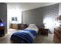Cozy bedroom with a brick accent wall, providing a unique and stylish look at 3008 Saint George St # B, North Las Vegas, NV 89030