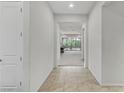 Bright hallway with neutral-toned tile flooring, leading to the living area at 44 Strada Caruso, Henderson, NV 89011