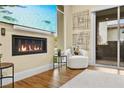 Living room view of fireplace, adjacent chair, and sliding glass doors to the exterior at 11280 Granite Ridge Dr # 1075, Las Vegas, NV 89135