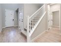 Light and bright entryway with hardwood floors and staircase at 2667 Kindswood St, Henderson, NV 89044