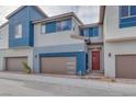 Contemporary townhome with red front door and two-car garage at 2667 Kindswood St, Henderson, NV 89044