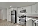 Updated kitchen featuring stainless steel appliances and light wood flooring at 512 Purcell Dr, Las Vegas, NV 89107