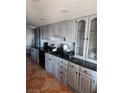 Bright kitchen with ample cabinetry, granite countertops, and tile floors at 1708 Weeping Willow Ln, Las Vegas, NV 89104