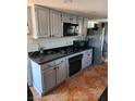 Bright kitchen with ample cabinetry, granite countertops, and tile floors at 1708 Weeping Willow Ln, Las Vegas, NV 89104