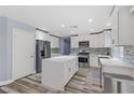 Modern kitchen featuring white cabinets and island at 8774 Libertyvale Dr, Las Vegas, NV 89123