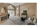 Bright living room featuring a fireplace and large windows at 2134 Eaglepath Cir, Henderson, NV 89074