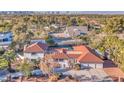 Beautifully landscaped property featuring a red tile roof, circular driveway, and mature trees at 2868 Vista Del Sol Ave, Las Vegas, NV 89120