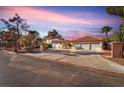 Gorgeous home with a three-car garage, lush landscaping, and brick-trimmed driveway at 2868 Vista Del Sol Ave, Las Vegas, NV 89120
