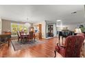 Elegant dining room with hardwood floors, stylish chandelier, and ample natural light at 3841 Hildebrand Ln, Las Vegas, NV 89121