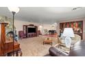 Inviting living room with stone fireplace, plush carpeting, and classic furnishings at 3841 Hildebrand Ln, Las Vegas, NV 89121