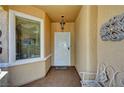 Inviting covered front entryway with decorative security door and tiled floor at 2820 Goldcreek St, Henderson, NV 89052