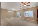 Bright living room featuring tiled floor, ceiling fan and sliding glass doors to the backyard at 2820 Goldcreek St, Henderson, NV 89052