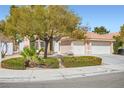 Charming home with a tile roof, manicured front yard, and a two-car garage in a residential neighborhood at 3134 Alfa Romero Ave, North Las Vegas, NV 89031