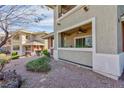 Building exterior featuring patios, desert landscaping and neutral paint at 905 Domnus Ln # 101, Las Vegas, NV 89144