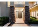 Grand entrance with stone pillars, a modern front door, and a welcoming pathway at 605 Canyon Greens Dr, Las Vegas, NV 89144