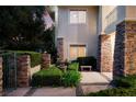 Beautiful home facade with stone accents, manicured shrubs and a gated entrance at 605 Canyon Greens Dr, Las Vegas, NV 89144