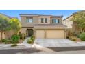 Two-story home with stone accents, desert landscaping, and a two-car garage on a sunny day at 9143 Irish Elk Ave, Las Vegas, NV 89149