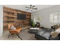 Stylish living room with a wood accent wall, modern furniture, and bright natural light at 9143 Irish Elk Ave, Las Vegas, NV 89149