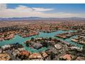 Aerial view of lakefront community with mountain backdrop at 2805 High Sail Ct, Las Vegas, NV 89117
