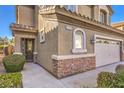 Front entrance and walkway of two story house with landscaping at 315 Foster Springs Rd, Las Vegas, NV 89148