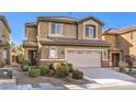 Two-story house with tan exterior, large garage, and landscaping at 315 Foster Springs Rd, Las Vegas, NV 89148