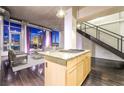 Modern kitchen with island and dark hardwood floors, overlooking the living area at 360 E Desert Inn Rd # 807, Las Vegas, NV 89109